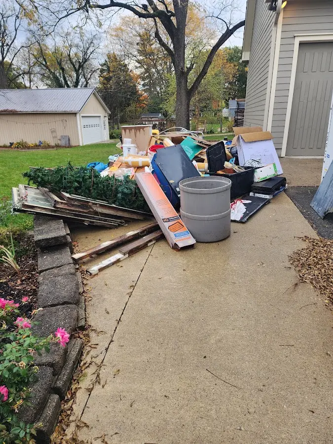 Dumpster being loaded with debris for Residential Dumpster Rental in Iuka
